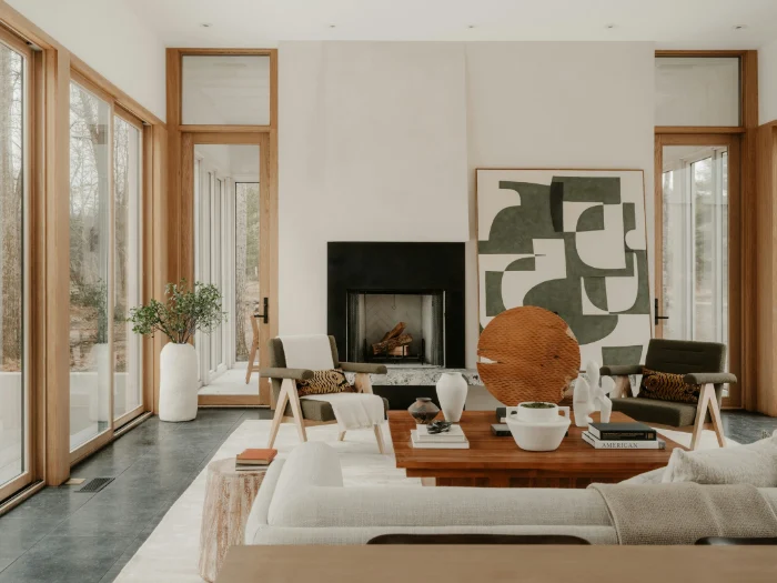 Living room with a black fireplace, a large green and white artwork and oak-framed glass doors