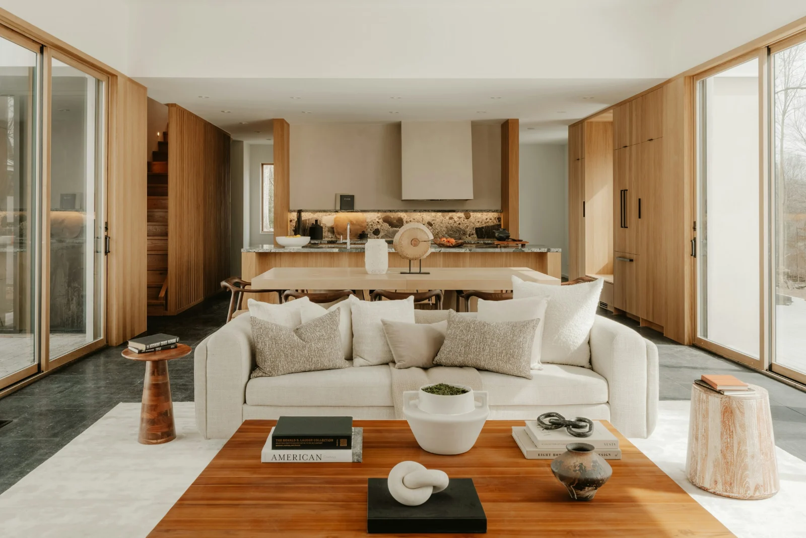 Open-plan living room with a cream sofa, a wooden coffee table and an oak kitchen behind