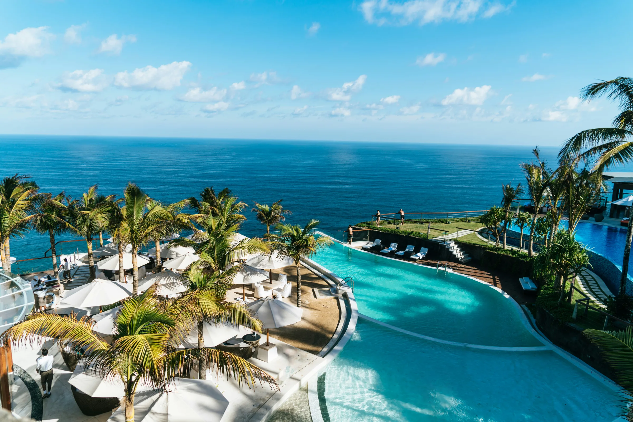 A curved pool and sun terraces overlooking the open sea