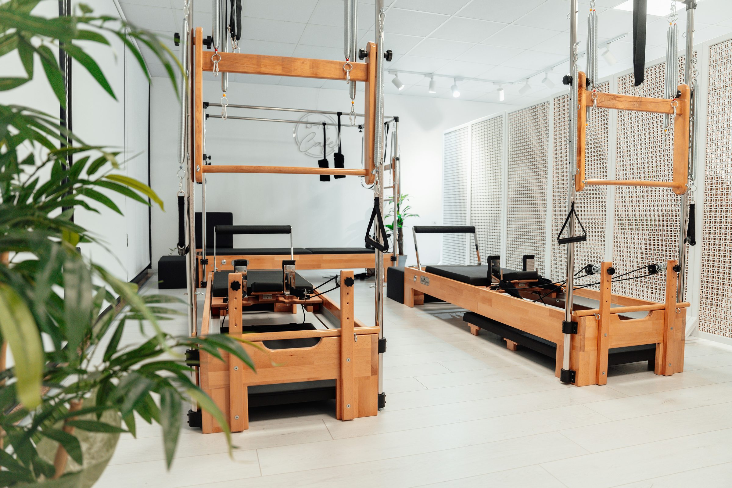 A light exercise studio with pale wood training equipment