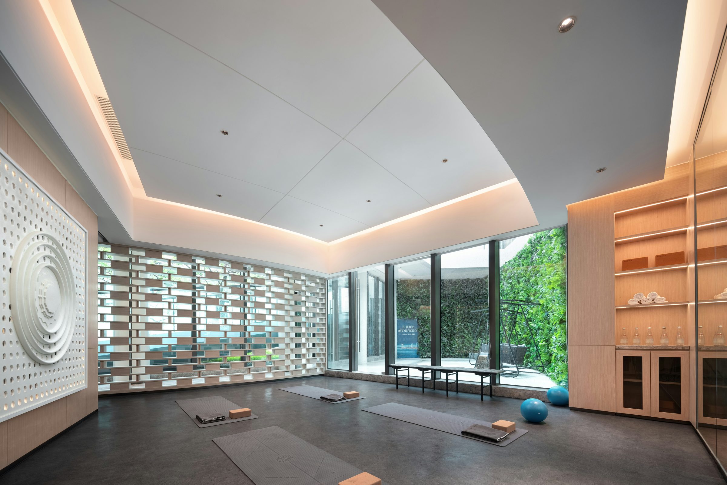 An empty contemporary movement studio with pale timber and full-height windows